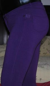 shiny black bodysuit and tight purple pants